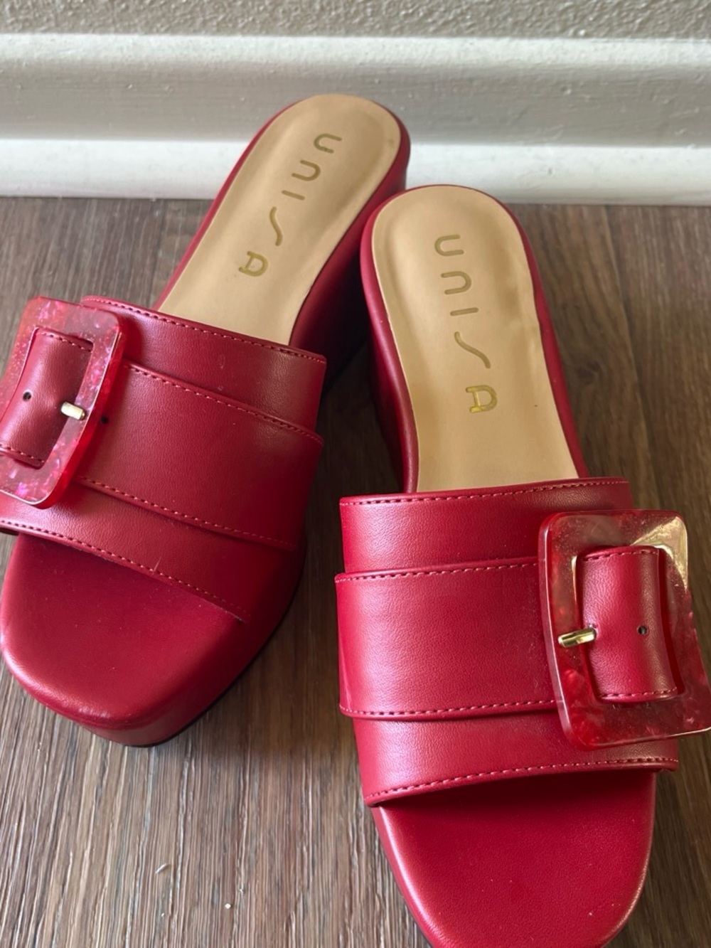 Red Unisa mules with buckle detail